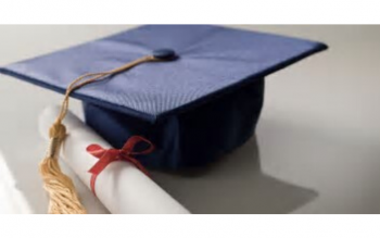 photo of mortarboard graduation cap next to a scroll with a red ribbon tied around it