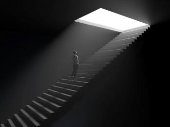 woman walking up underground stairwell toward opening with light coming through