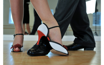 image of feet of tango dancers woman's foot in a high-heel eloquently pointed