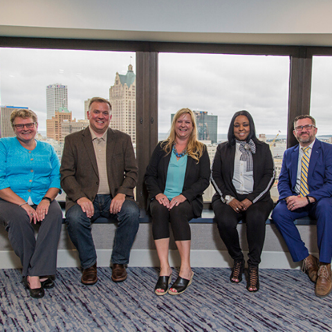 Six 2018 AFPSEWI leaders posing for photo with skyline of Milwaukee in background
