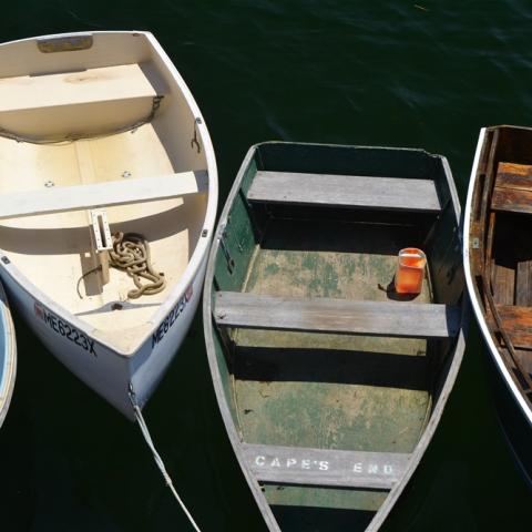 image of small wood boats tied together in a harbor
