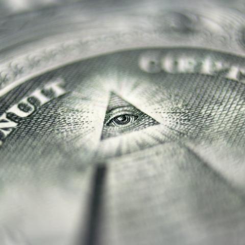 Close-up image of the pyramid with an eye on the US dollar bill