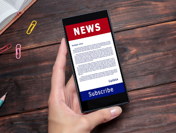 image of female hand holding mobile phone with "NEWS" as headline