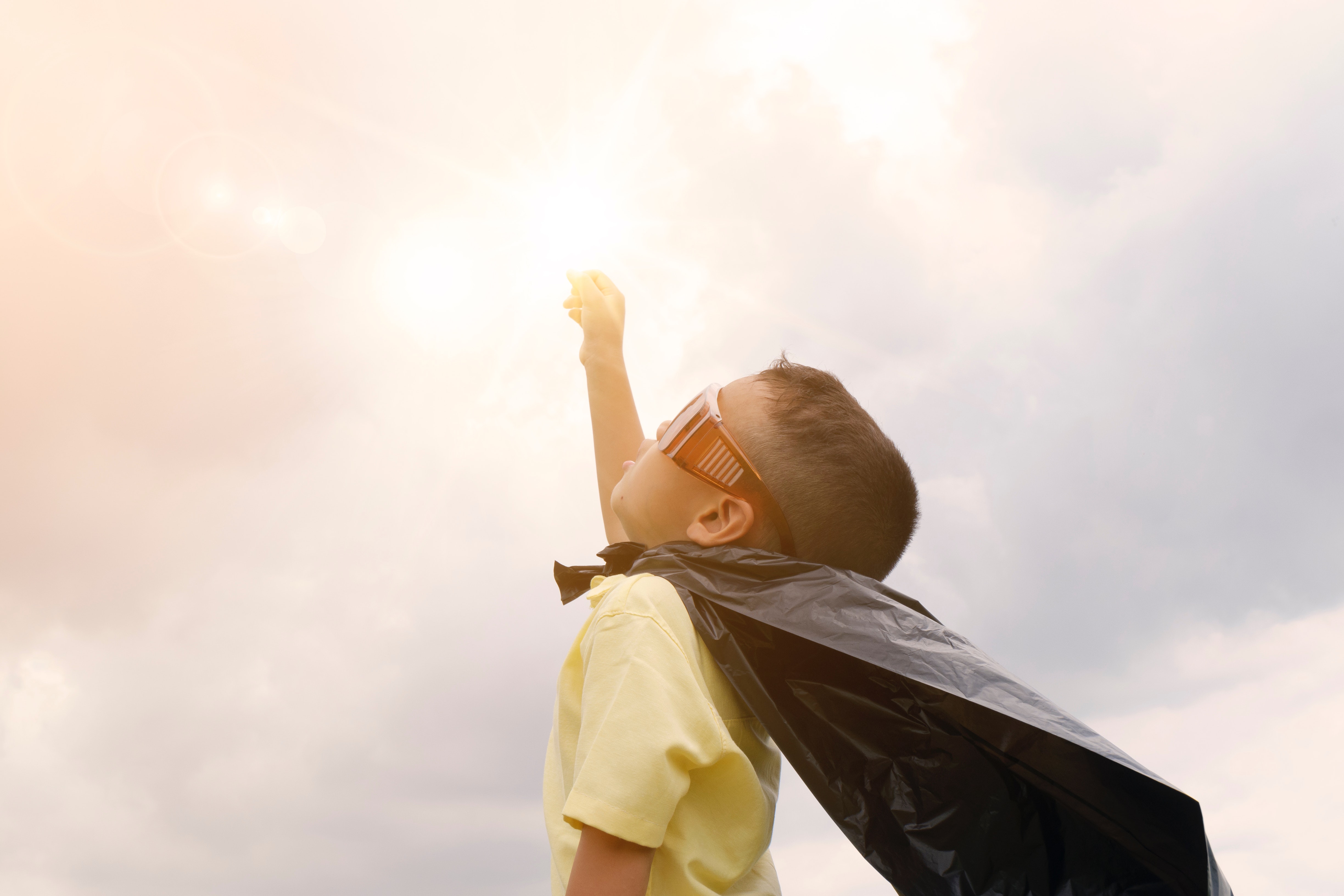 boy pretending to be a super hero