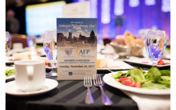 photo of 2017 event program standing on event table dressed and ready with salads for guests