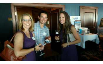 Three AFP members with wine posing for a picture