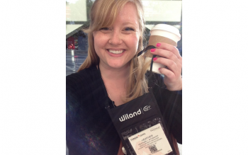 photo of Heather Stoskopf holding up her conference name badge