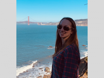 Katerina Herder standing on shore with Golden Gate bridge in the background