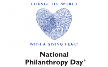 "Change the World with a Giving Heart" NPD logo with a heart formed with two fingerprints