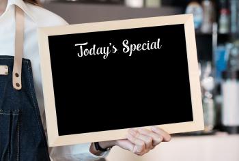 person holding chalk board sign that says "Today's Special"