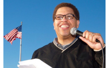 Tony Shields with microphone in hand at a speaking engagement