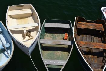 image of small wood boats tied together in a harbor
