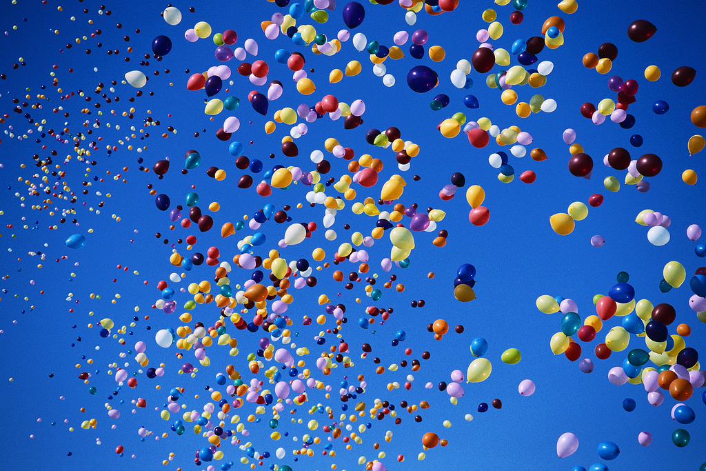 colorful balloons flying against blue sky