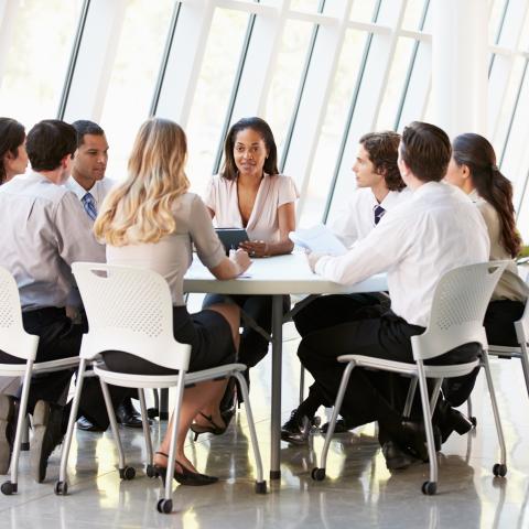 group of professionals sitting at round table