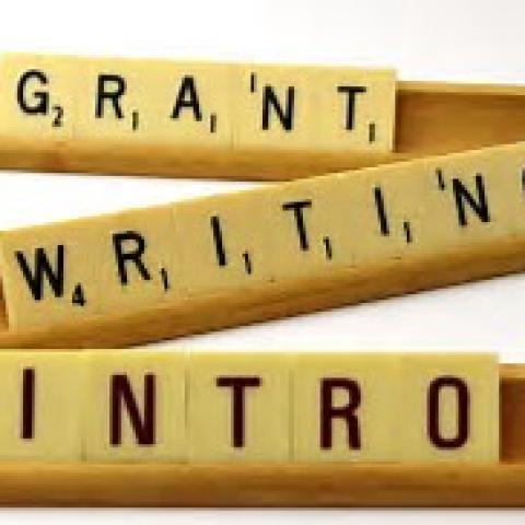 "Grant Writing Intro" spelled out with Scrabble tiles