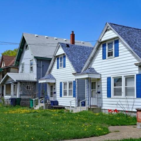 picture of three homes and green grass lawn