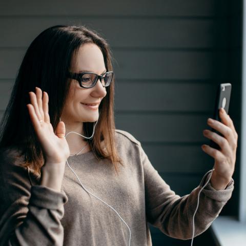 Woman face timing on her mobile phone