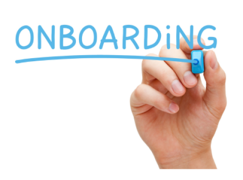 a hand writing the word onboarding on a white board