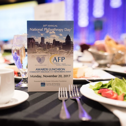 photo of 2017 event program standing on event table dressed and ready with salads for guests