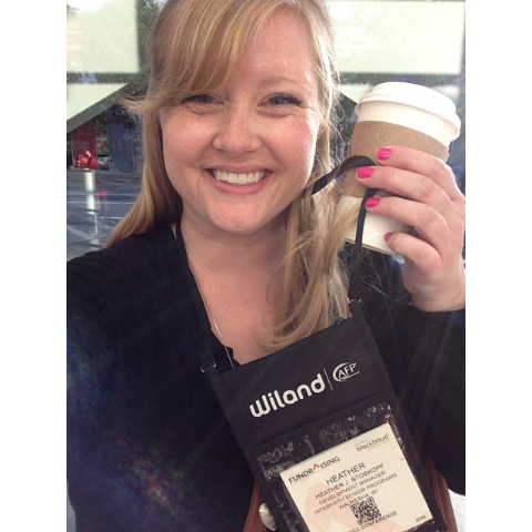 photo of Heather Stoskopf holding up her conference name badge