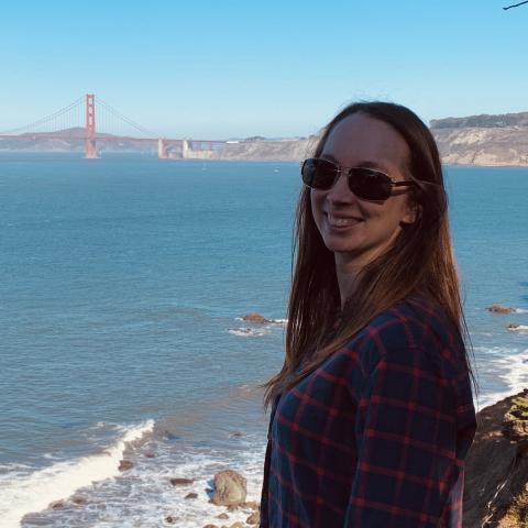 Katerina Herder standing on shore with Golden Gate bridge in the background