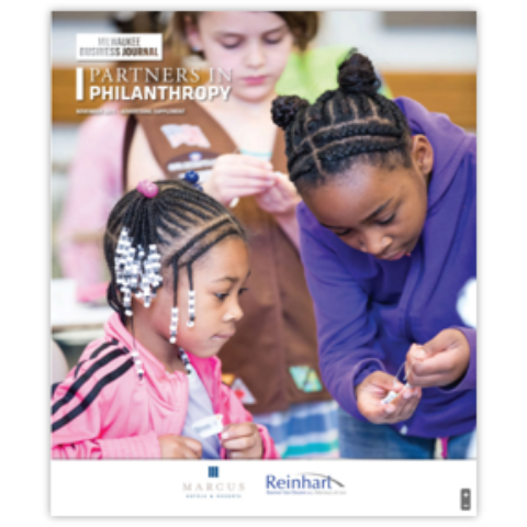 Cover of Milwaukee Business Journal's 2019 Partners in Philanthropy magazine with image of two young black girls working on a crafts project together