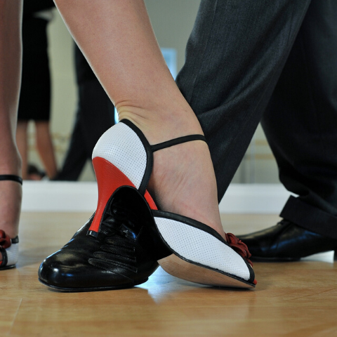 image of feet of tango dancers woman's foot in a high-heel eloquently pointed