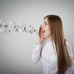 woman holding hand at mouth yelling with images of letters coming from her mouth/voice