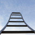 photo taken of climbing gym stairs from the bottom looking upward to the sky