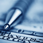 close up image of tip of a pen on top of a dollar bill