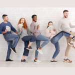 five young people dancing with a fan of cash in their hand