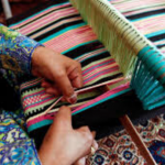 image of woman weaving on a loom